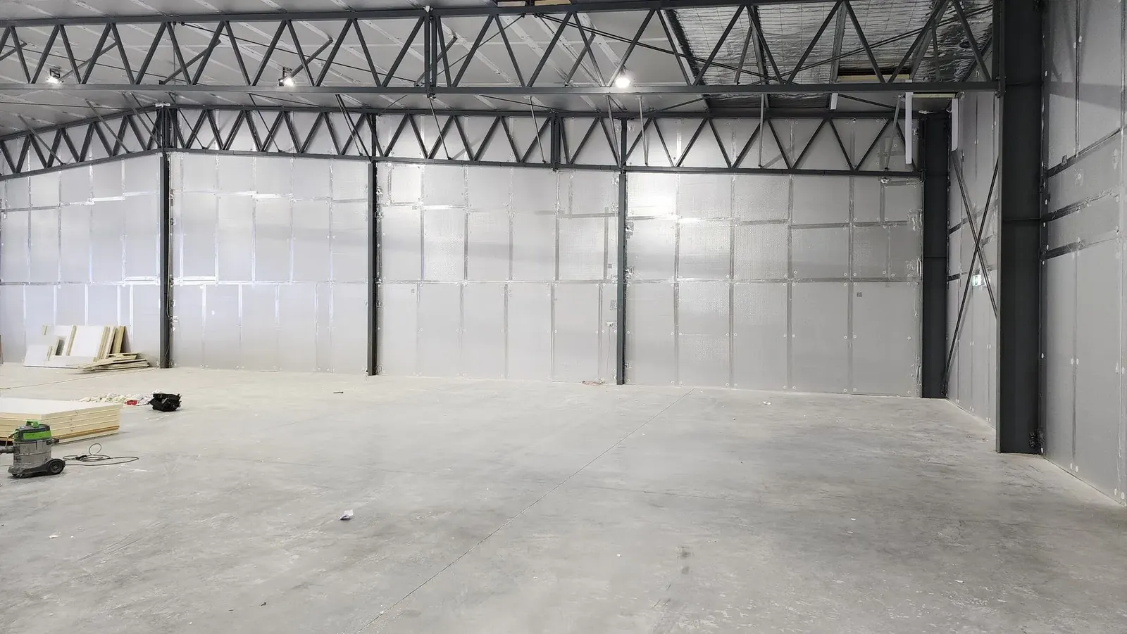 Reflective foil insulation lining the walls of a commercial shed